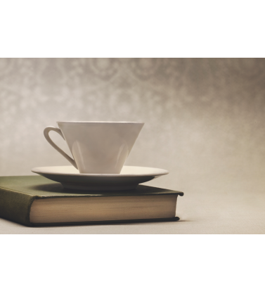 Чашка с блюдцем на книге